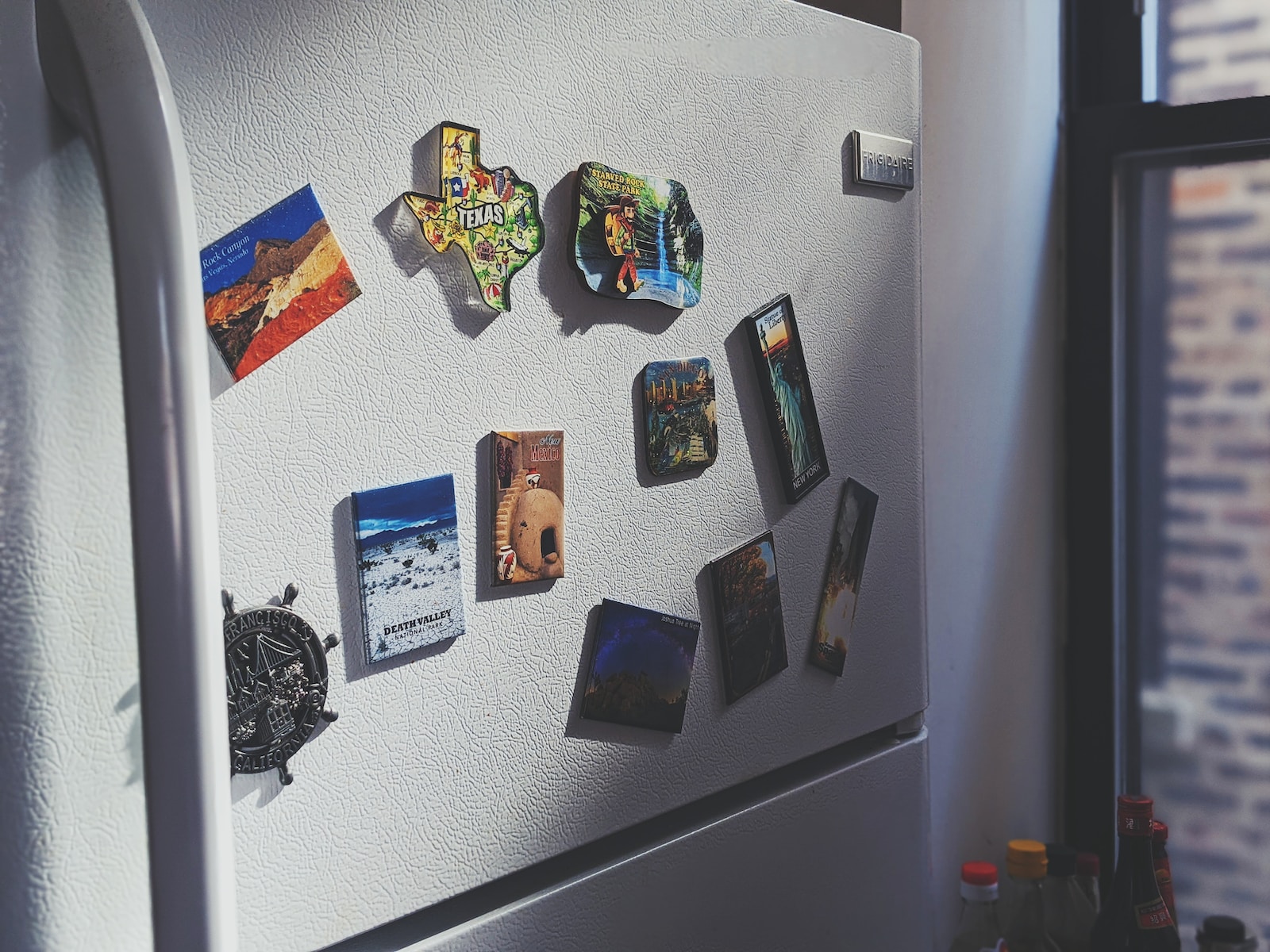 gray top mount refrigerator with stickers